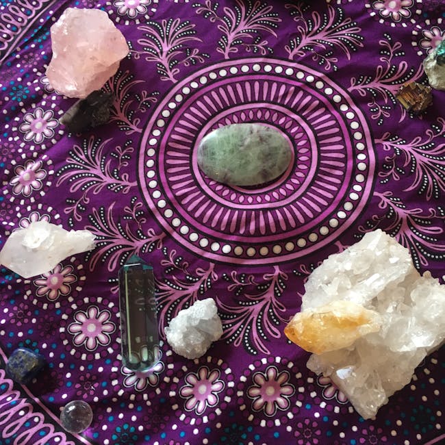A vibrant display of healing crystals arranged on a decorative mandala cloth, showcasing a blend of colors and textures.